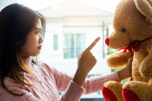girl-scolding-teddy-bear-bedroom-her-home_1150-15719.jpg